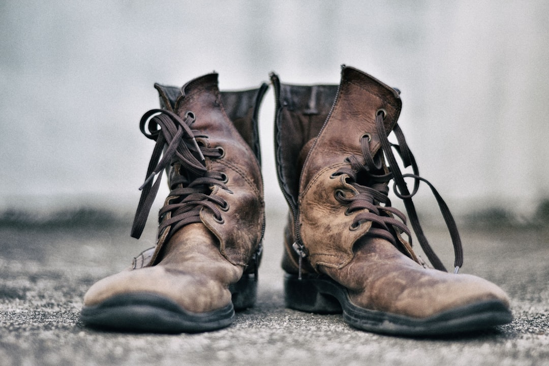AI History - pair of brown leather boots in pavement