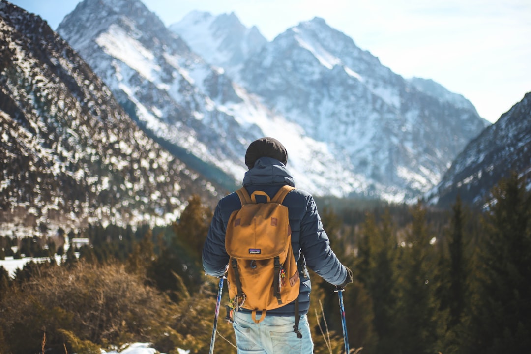 AI History - man holding pair of ski poles in front of trees