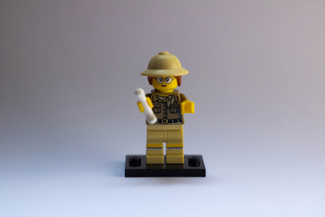 AI History - brown robot toy on white table