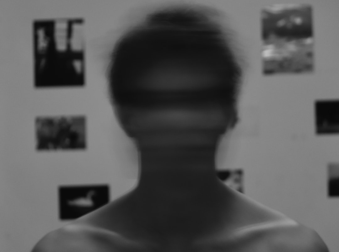 deepfake video - a blurry image of a man's face in front of a wall with