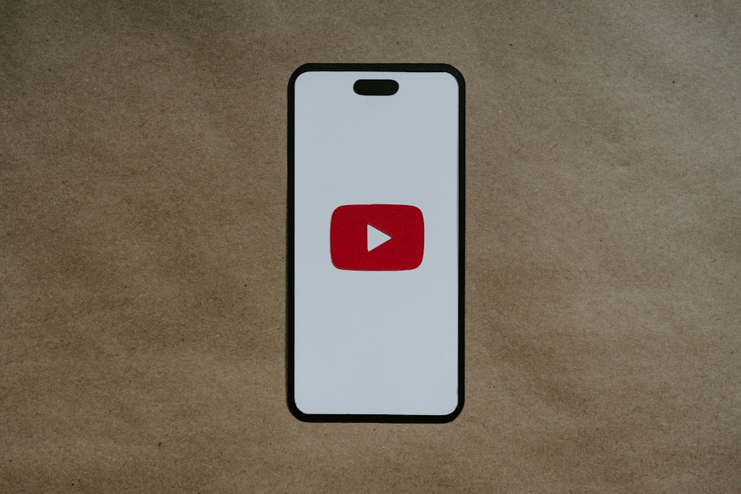 deepfake video - a white phone with a red youtube logo on it