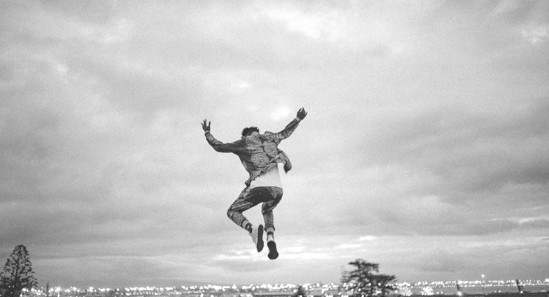 AI insurance - greyscale photo of person jumping